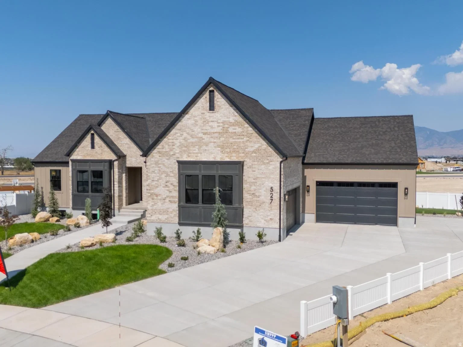 An Eagle Point Homes example with a stone entry, broad windows, and landscaped front yard