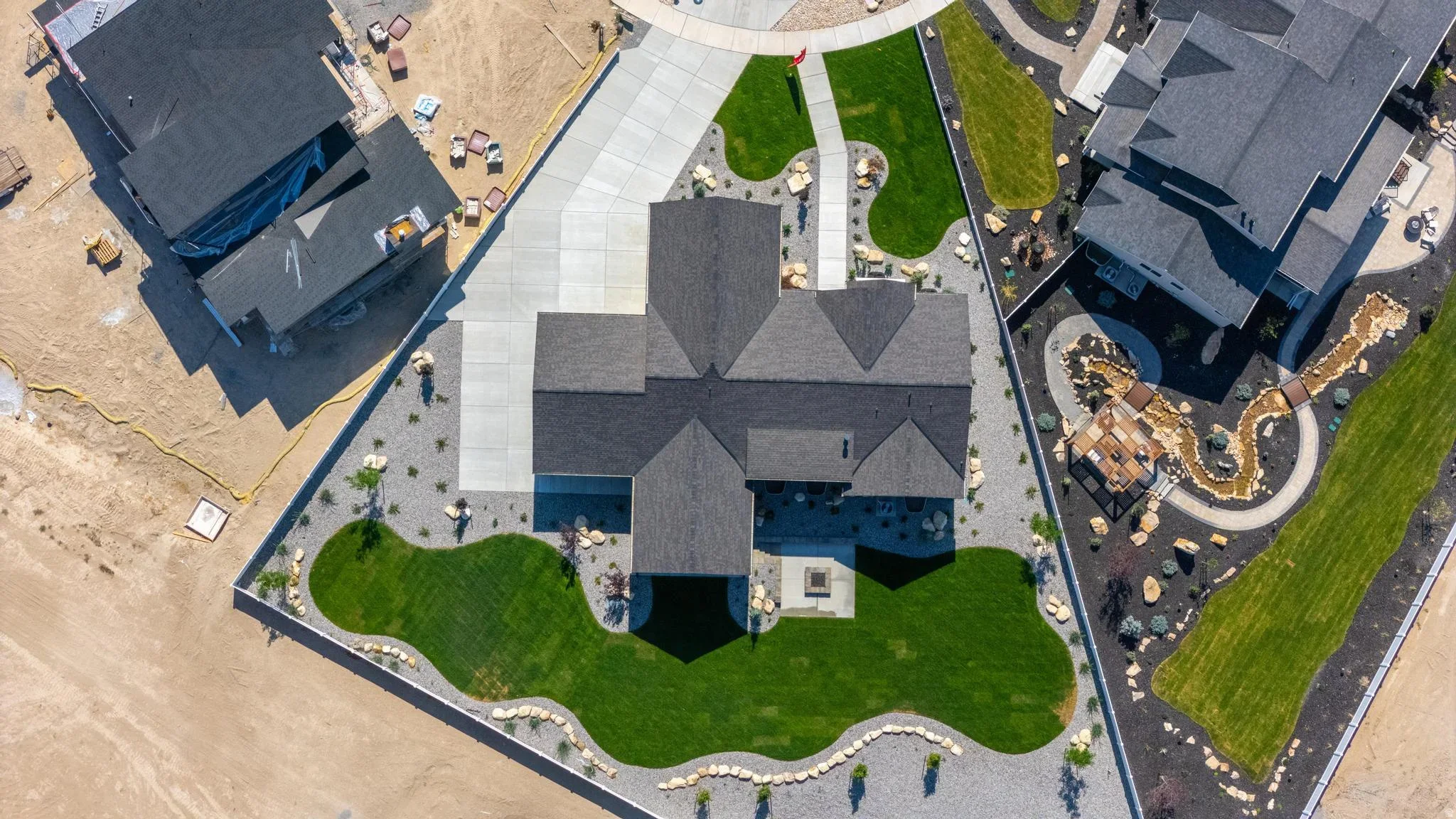 An Eagle Point Homes example and nearby developed lots seen from above