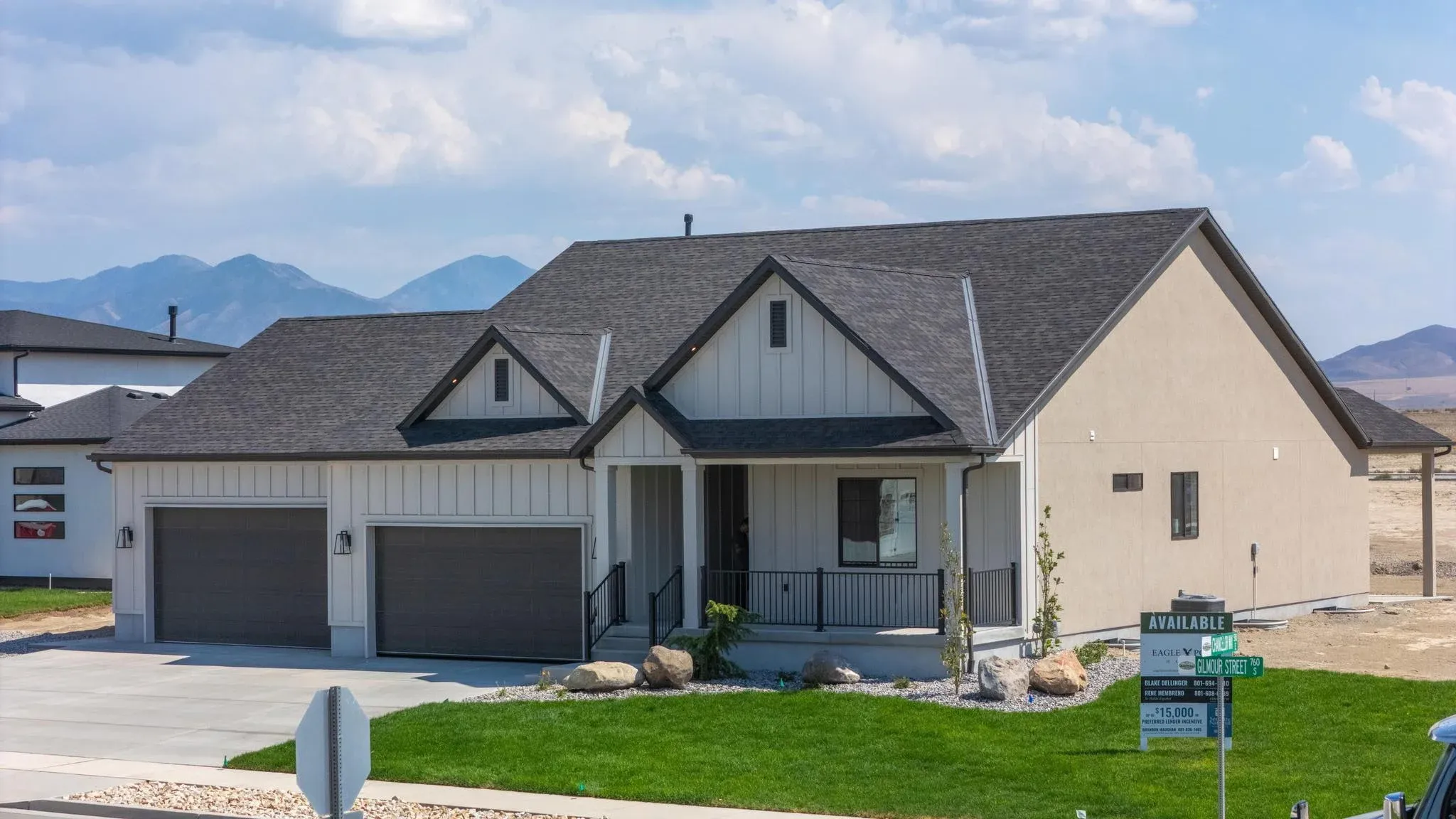 An Eagle Point Homes Kennedy-plan example with a covered entry and three-car garage