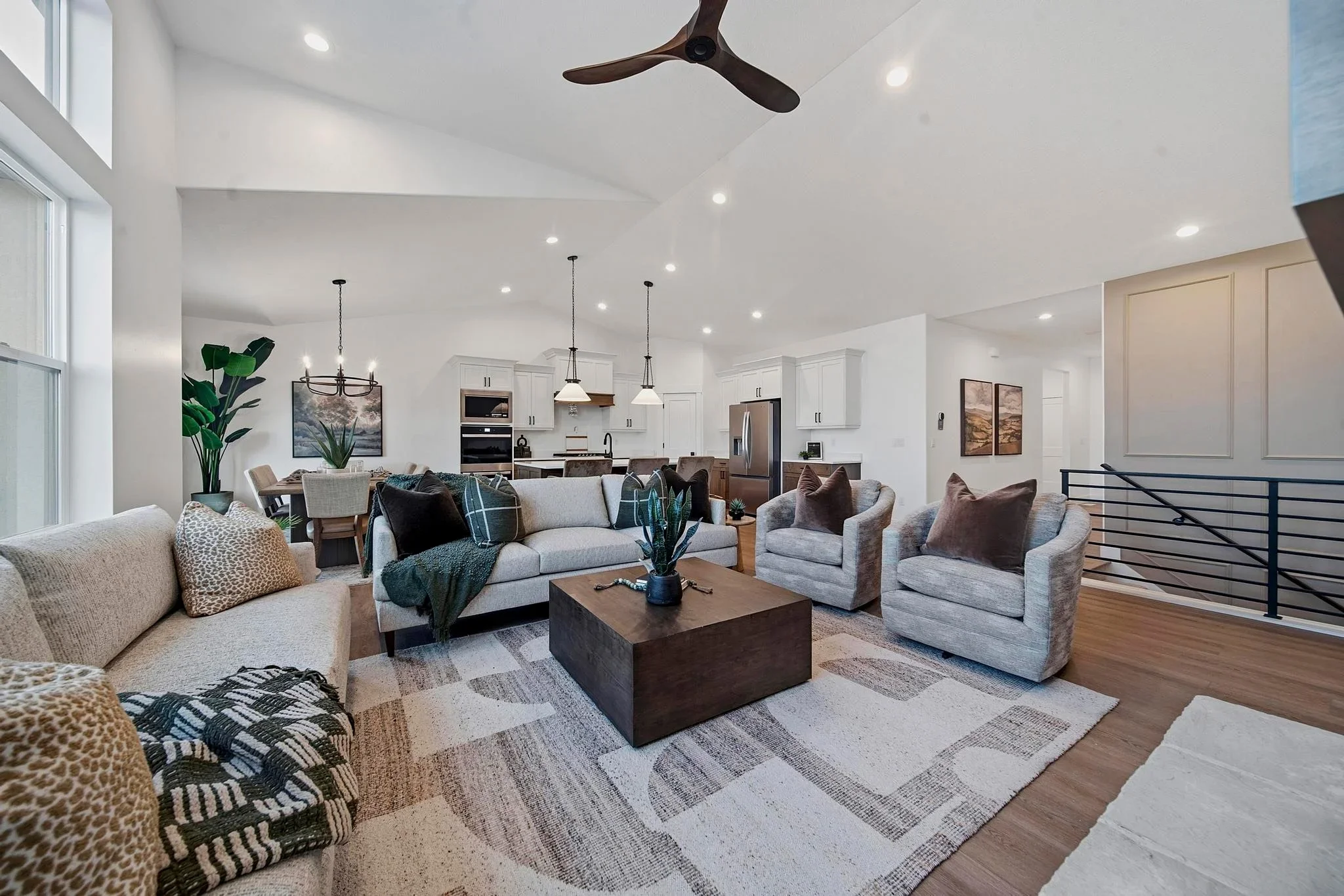 An Eagle Point Homes living room opening into a bright kitchen and dining area