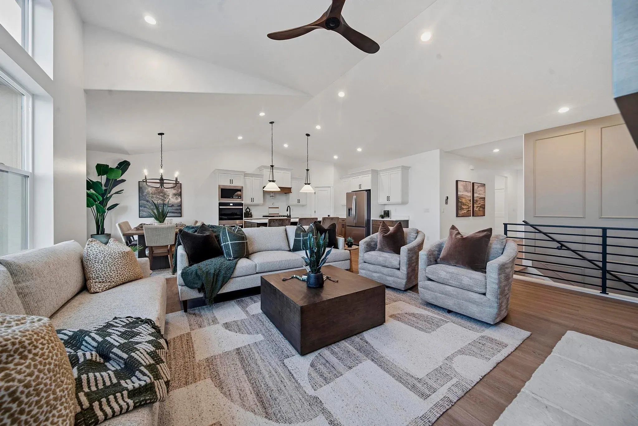 An Eagle Point Homes living room opening into a bright kitchen and dining area